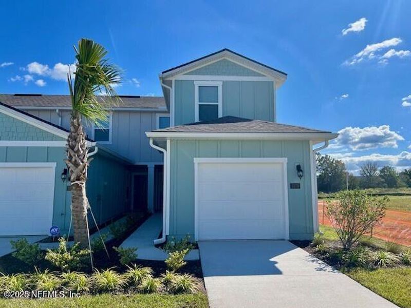 Front exterior of a new home in Corsair, Middleburg, FL, highlighting curb appeal (Image 1).