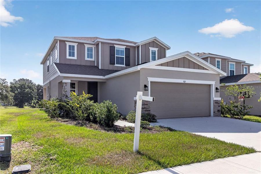 Front exterior of a new home in Seasons at Forest Creek, Haines City, FL, highlighting curb appeal (Image 31).