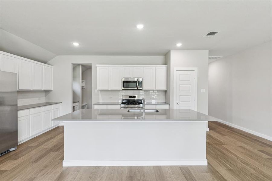 Kitchen in the Heisman home plan by Trophy Signature Homes – REPRESENTATIVE PHOTO Kitchen in the Heisman home plan by Trophy Signature Homes – REPRESENTATIVE PHOTO