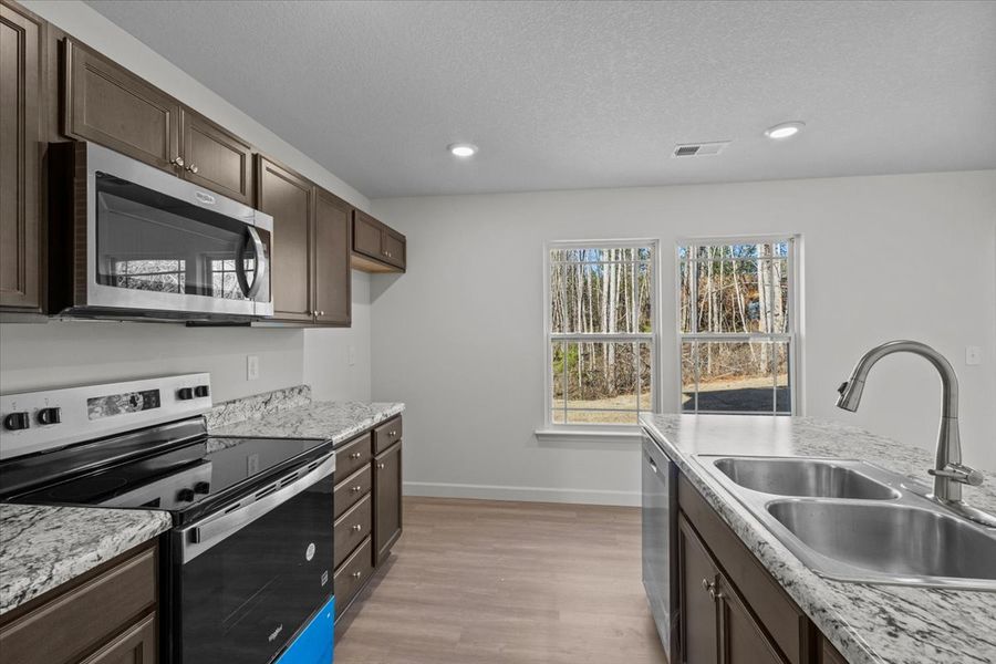 Representative furnished interior of a home built from the Roebuck by Enchanted Homes in Las Palomas Country Club Estates, La Vernia (Image 5).