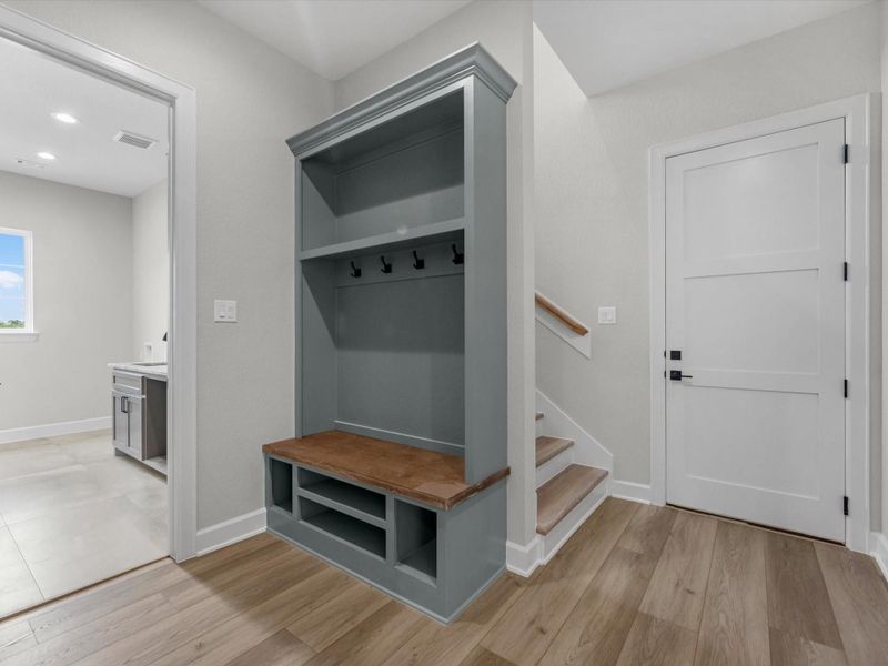 Custom mudroom with built-in bench, storage, and convenient drop zone.