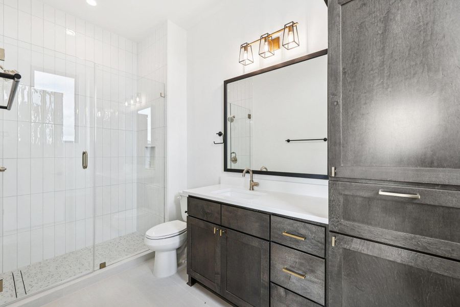 Full bathroom with vanity, a shower stall, and light tile patterned floors