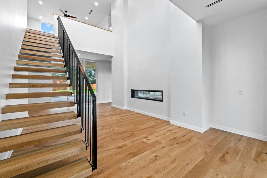 Floating Stairs and See-Thru Fireplace: 72" Linear Gas- Direct Vent with Glass Media.  Fireplace is shared with the Great Room.