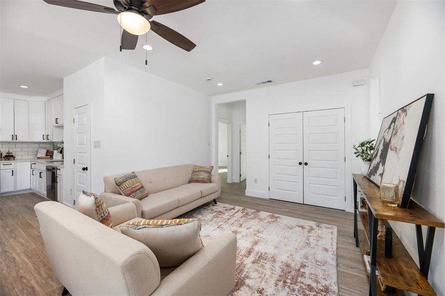 Living room featuring recessed lighting, wood finished floors, and ceiling fan Living room featuring recessed lighting, wood finished floors, and ceiling fan