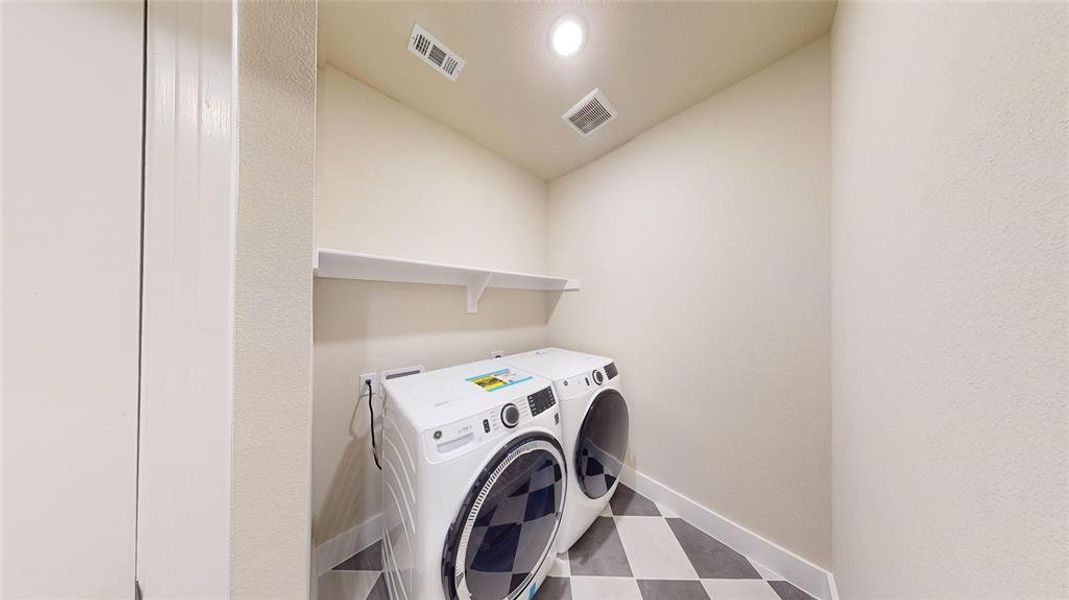 Clothes washing area featuring washer and clothes dryer