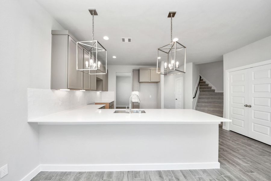 The open concept effortlessly connects the kitchen to the expansive family room, forming a perfect hub for gatherings. This seamless flow creates an inviting space where cooking and socializing come together harmoniously. Sample photo of completed home with similar floor plan. Actual colors and selections may vary. The open concept effortlessly connects the kitchen to the expansive family room, forming a perfect hub for gatherings. This seamless flow creates an inviting space where cooking and socializing come together harmoniously. Sample photo of completed home with similar floor plan. Actual colors and selections may vary.