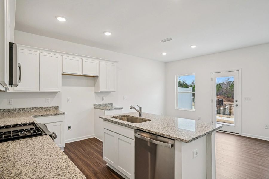 Kitchen - Chic white finishes and smooth surfaces shine.