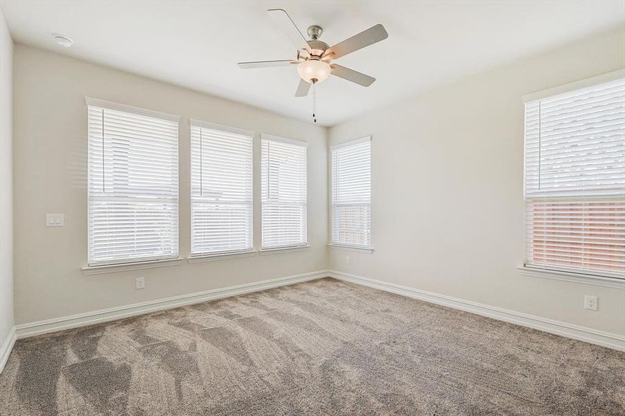 Spare room featuring carpet floors and ceiling fan