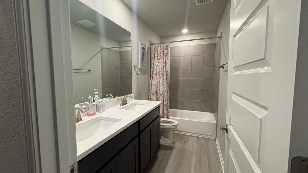 Dual vanity with bright lighting perfect for busy mornings.