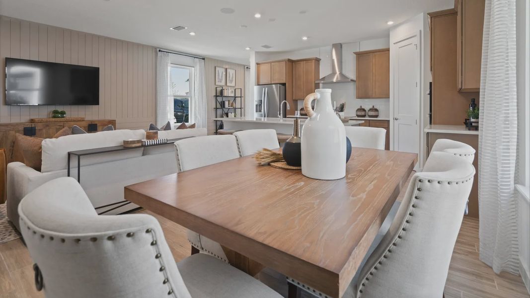 Open main floor cafe, family room and kitchen in a DRB Home Clementine model at the Trinity Place community.