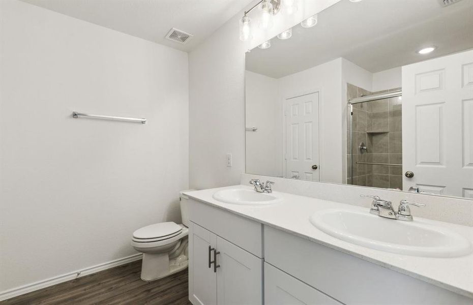 Owner's bathroom with dual vanity *real home pictured