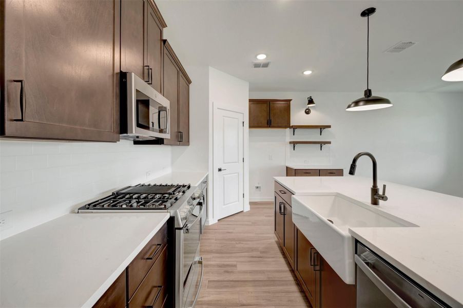 Stylish kitchen with dark stain cabinets and floating shelves