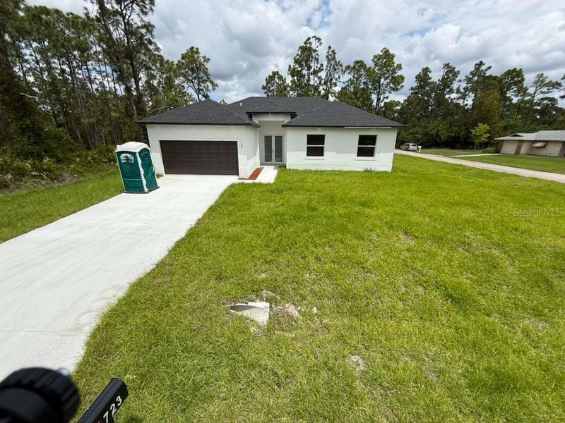 Front exterior of a new home in , Lehigh Acres, FL, highlighting curb appeal (Image 17). Front exterior of a new home in , Lehigh Acres, FL, highlighting curb appeal (Image 17).