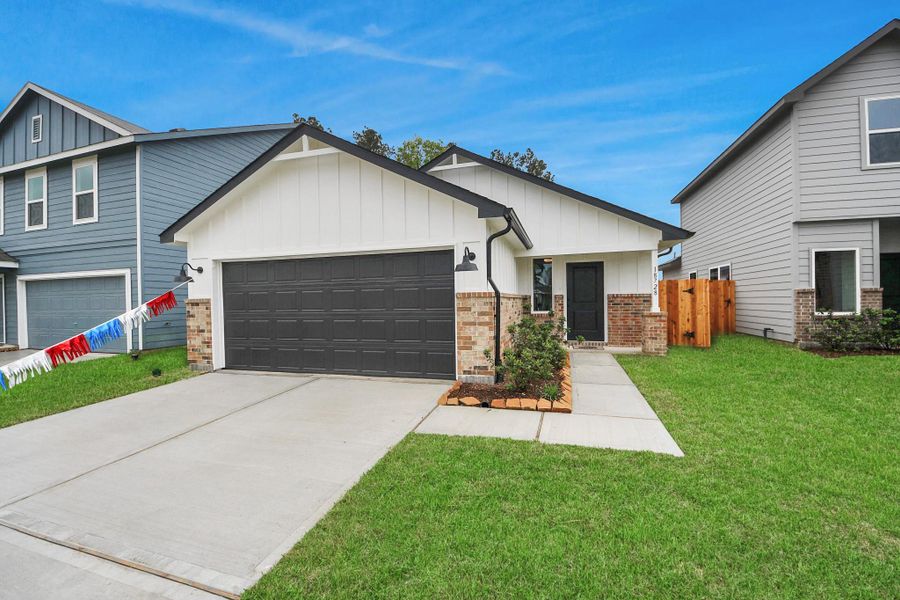 Front exterior of a new home in The Enclave at Spring Branch, Montgomery, TX, highlighting curb appeal (Image 24). Front exterior of a new home in The Enclave at Spring Branch, Montgomery, TX, highlighting curb appeal (Image 24).