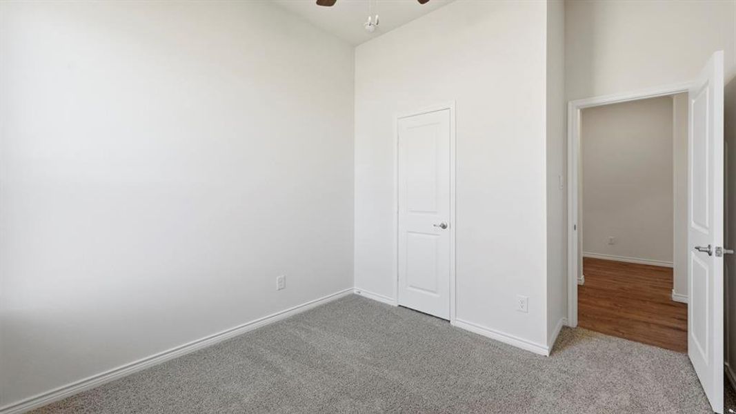 Unfurnished bedroom with carpet and ceiling fan Unfurnished bedroom with carpet and ceiling fan