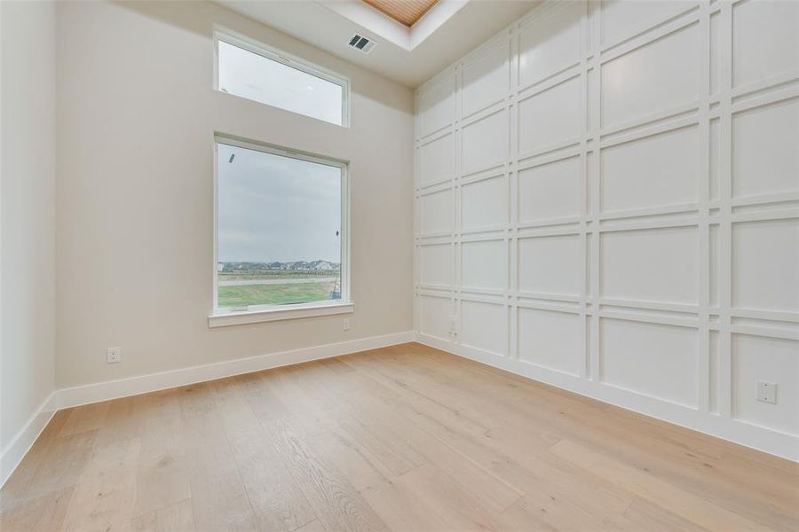 Spare room with light wood finished floors and baseboards Spare room with light wood finished floors and baseboards