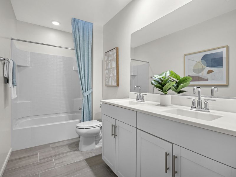 Upstairs bathroom with dual sinks.