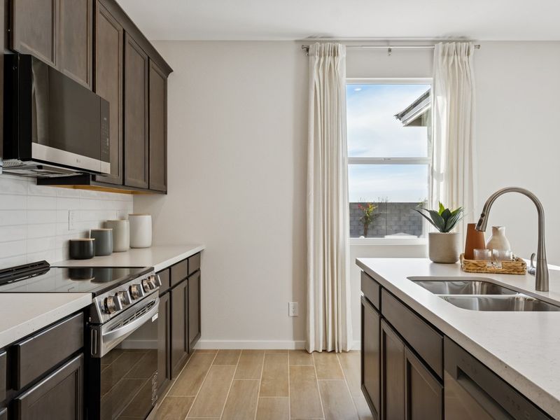 A kitchen with a stove and a sink. A kitchen with a stove and a sink.