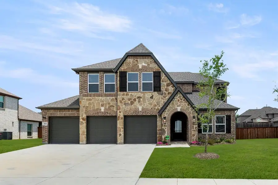 Front exterior of a new home in Grayhawk Addition, Forney, TX, highlighting curb appeal (Image 2).