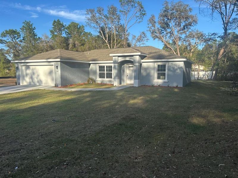 Front exterior of a new home in , Dunnellon, FL, highlighting curb appeal (Image 1).