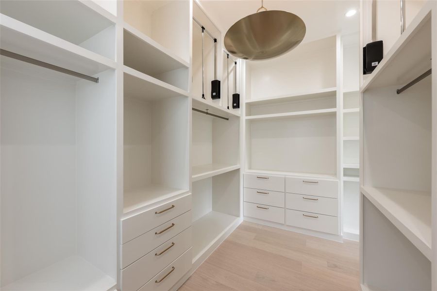 The expansive primary closet is thoughtfully outfitted with custom built ins, dedicated drawers and abundant hanging space, creating a dressing room experience designed around organization. The expansive primary closet is thoughtfully outfitted with custom built ins, dedicated drawers and abundant hanging space, creating a dressing room experience designed around organization.