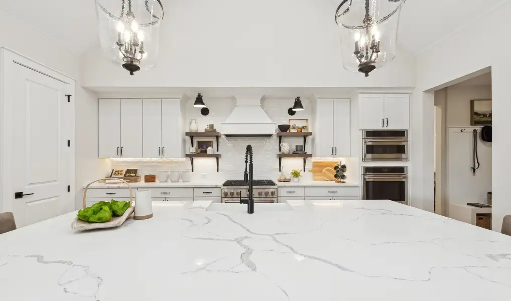 Kitchen with floating shelves and quartz countertops