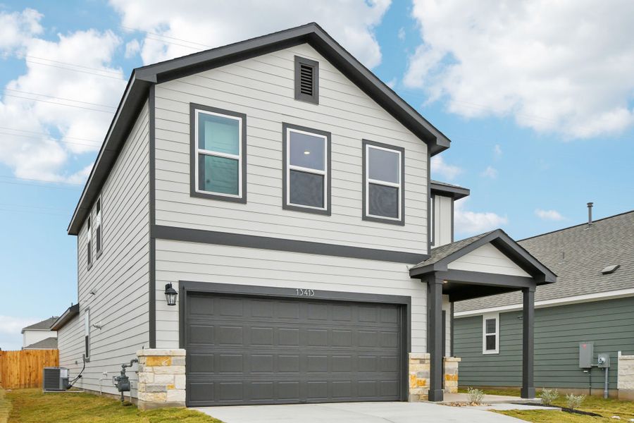A grey house with a garage.