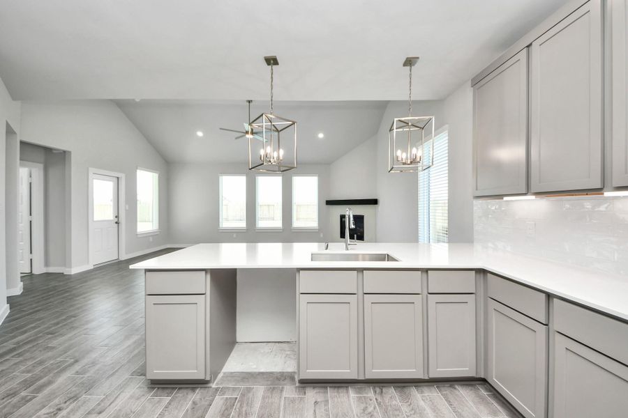 All of this overlooks your expansive family room, creating a perfect space for culinary delights and family gatherings. Sample photo of completed home with similar floor plan. Actual colors and selections may vary. All of this overlooks your expansive family room, creating a perfect space for culinary delights and family gatherings. Sample photo of completed home with similar floor plan. Actual colors and selections may vary.