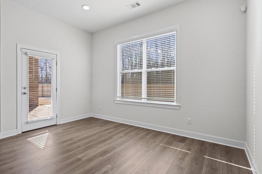 Spare room featuring wood finished floors and recessed lighting