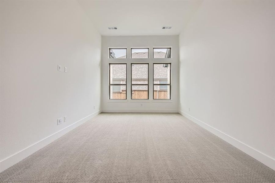Empty room with light carpet and baseboards