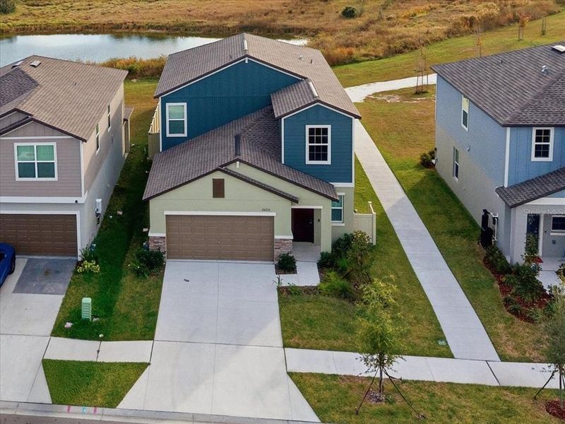 Front exterior of a new home in Two Rivers: The Manors II, Zephyrhills, FL, highlighting curb appeal (Image 1). Front exterior of a new home in Two Rivers: The Manors II, Zephyrhills, FL, highlighting curb appeal (Image 1).