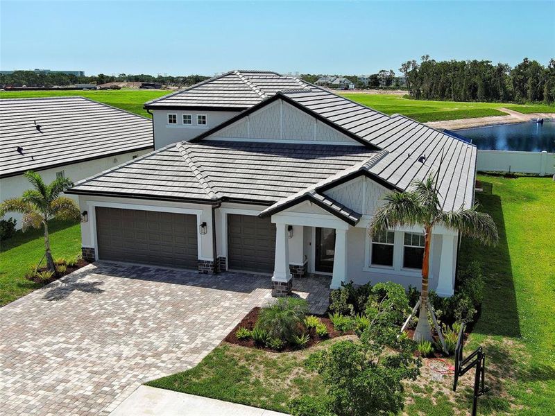 Front exterior of a new home in , Nokomis, FL, highlighting curb appeal (Image 1). Front exterior of a new home in , Nokomis, FL, highlighting curb appeal (Image 1).
