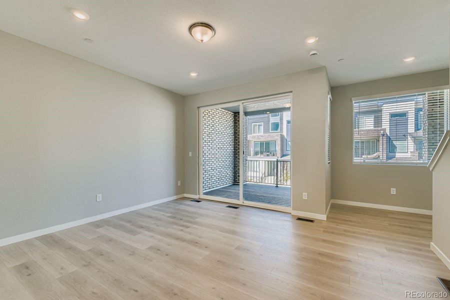 Great room with extended LVP flooring towards deck