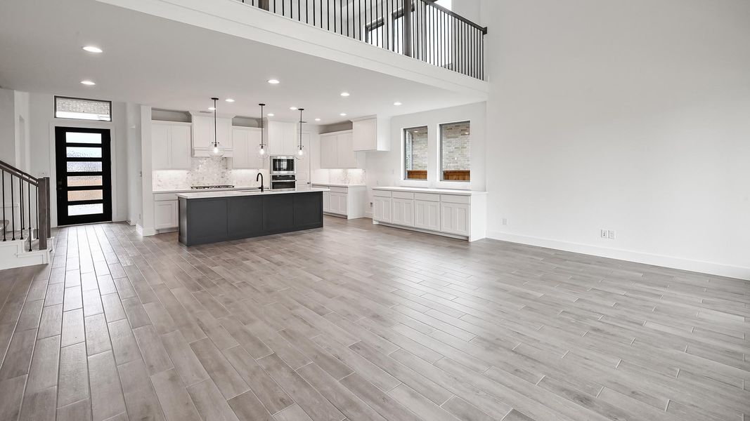 Living area with baseboards, stairs, recessed lighting, and light wood-type flooring