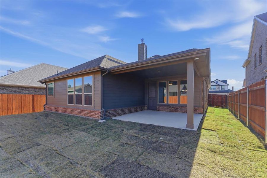 Back of property featuring a patio area, a fenced backyard, a chimney, and brick siding Back of property featuring a patio area, a fenced backyard, a chimney, and brick siding