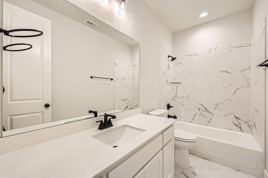 Bathroom with shower / bathing tub combination, vanity, recessed lighting, toilet, and marble finish floor Bathroom with shower / bathing tub combination, vanity, recessed lighting, toilet, and marble finish floor