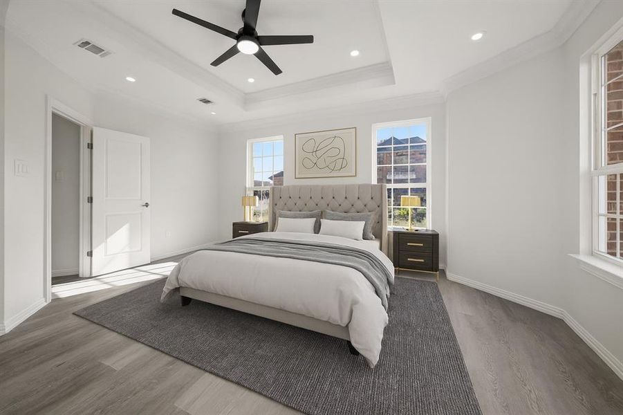Bedroom featuring wood finished floors, a tray ceiling, ceiling fan, crown molding, and recessed lighting Bedroom featuring wood finished floors, a tray ceiling, ceiling fan, crown molding, and recessed lighting