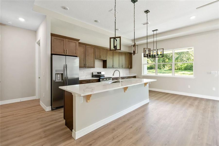 Custom Kitchen w/ quart countertops and tile backsplash