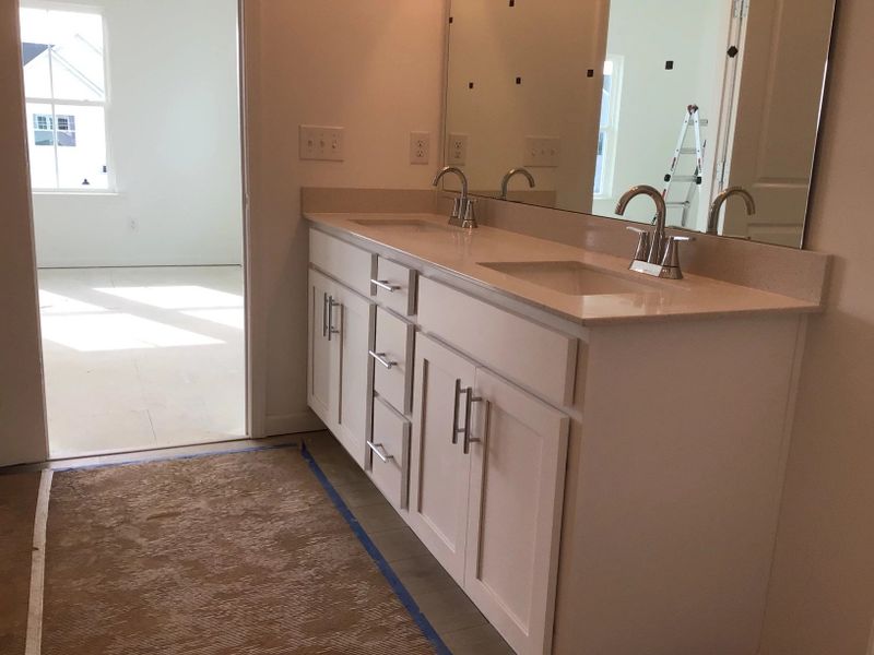 Primary Bath featuring the AW Collection® Coastal - Spa-like with white cabinets and light tile.