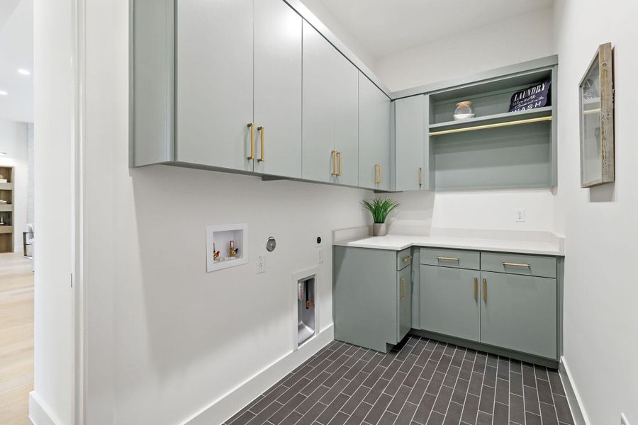 Laundry room with hookup for a gas dryer, hookup for a washing machine, cabinet space, and electric dryer hookup Laundry room with hookup for a gas dryer, hookup for a washing machine, cabinet space, and electric dryer hookup