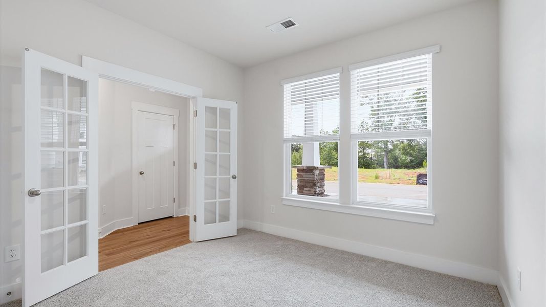 Tasteful French door study offering a quiet, elegant workspace in this vibrant Anderson home