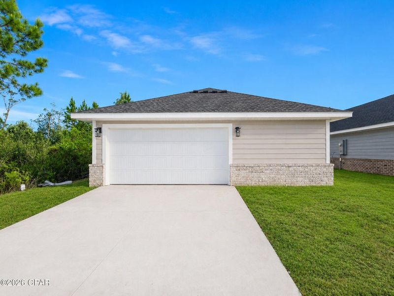 Front exterior of a new home in East Bay, Panama City, FL, highlighting curb appeal (Image 12). Front exterior of a new home in East Bay, Panama City, FL, highlighting curb appeal (Image 12).