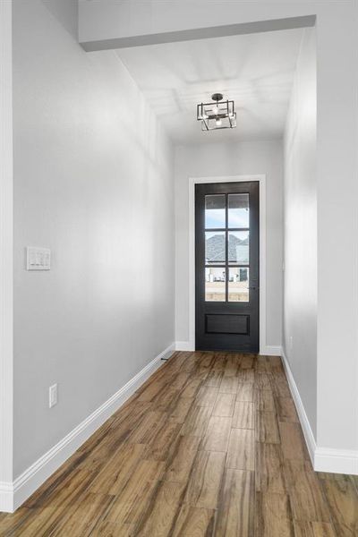 Doorway to outside with an inviting chandelier