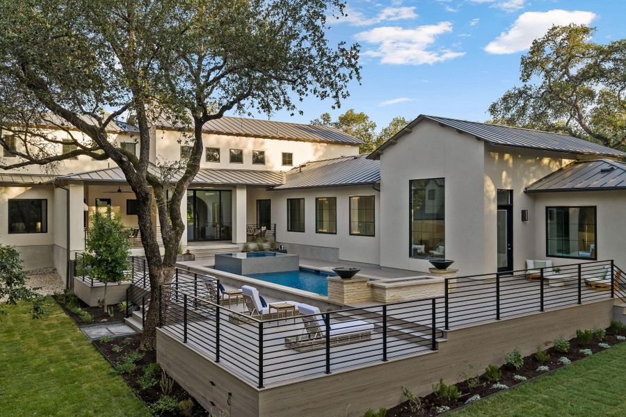 An inviting backyard oasis offers a serene pool and spa, perfect for relaxation and outdoor enjoyment.