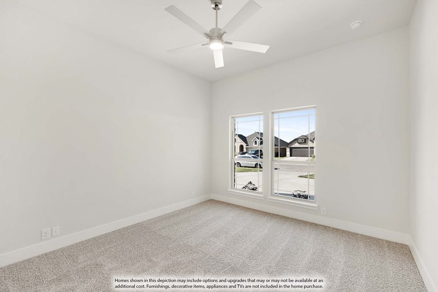 Empty bedroom with carpet flooring, ceiling fan, and two windows overlooking a neighborhood street. Empty bedroom with carpet flooring, ceiling fan, and two windows overlooking a neighborhood street.