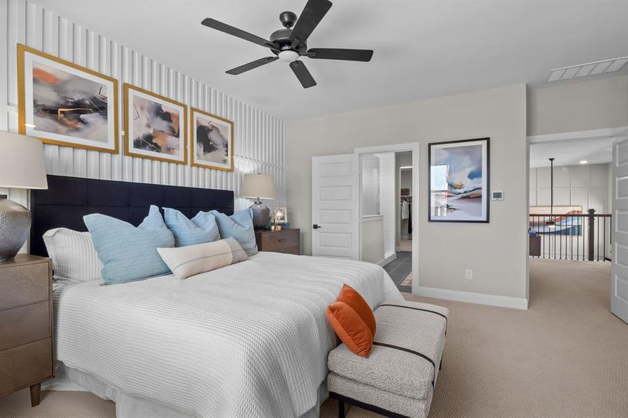Bedroom featuring wallpapered walls, carpet flooring, ensuite bath, and a ceiling fan