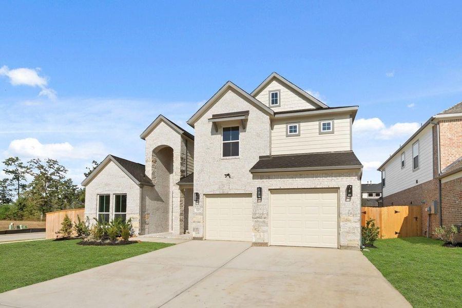 Front exterior of a new home in Barton Creek Ranch, Conroe, TX, highlighting curb appeal (Image 13).