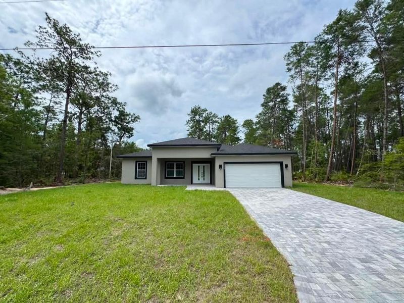 Front exterior of a new home in , Citrus Springs, FL, highlighting curb appeal (Image 17).