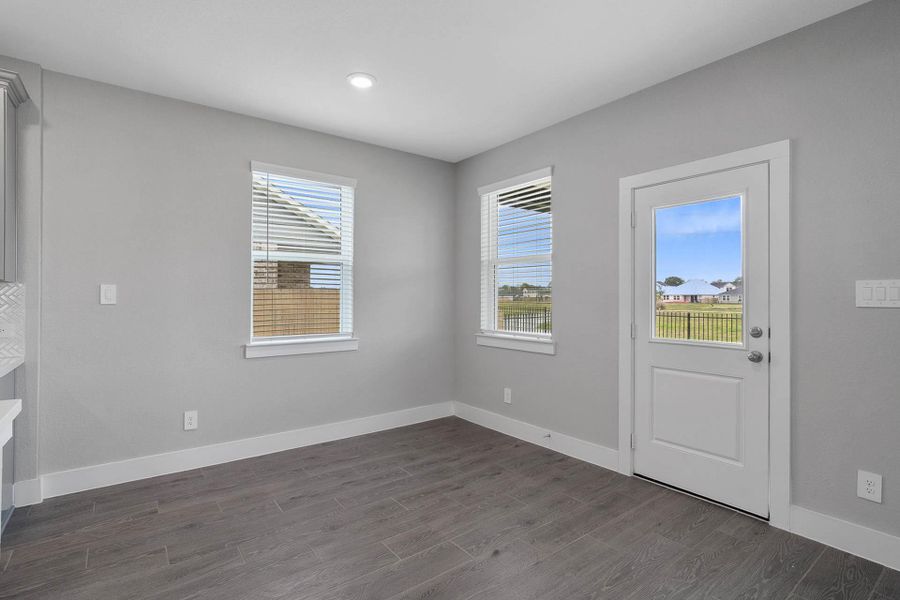 Enjoy meals in this sun-drenched space, featuring modern wood-look tile flooring, abundant natural light from the large windows, and convenient access to the back patio and yard - all with views of the Community lake and walking path. Enjoy meals in this sun-drenched space, featuring modern wood-look tile flooring, abundant natural light from the large windows, and convenient access to the back patio and yard - all with views of the Community lake and walking path.