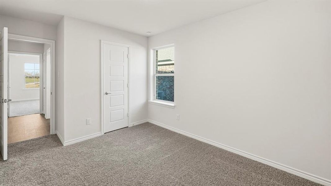 Unfurnished bedroom with carpet and a closet Unfurnished bedroom with carpet and a closet